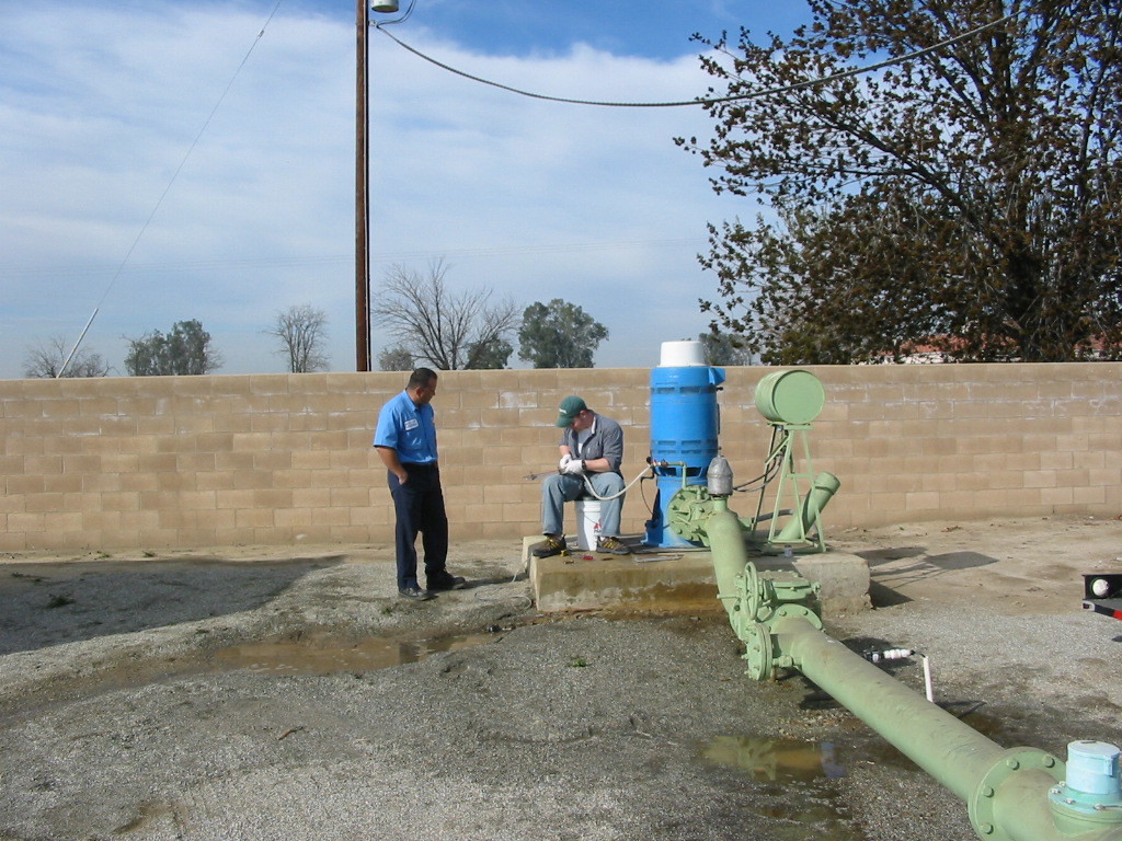 Well owner observing a USGS scientist sample a groundwater well.