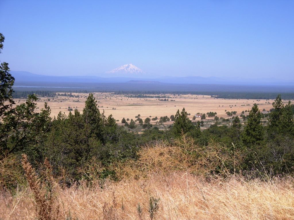 Hill in Modoc County of valley with Mt Shasta in the background
